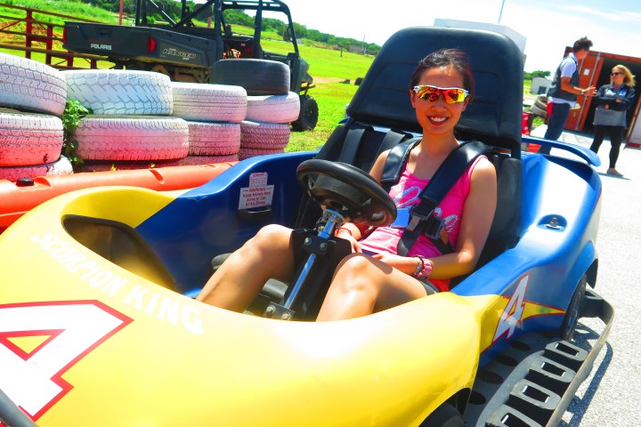 A woman having a fun time driving her go-kart