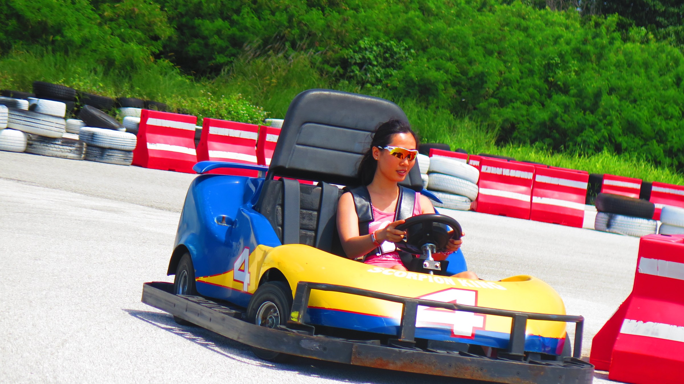 A woman having a fun time driving her go-kart