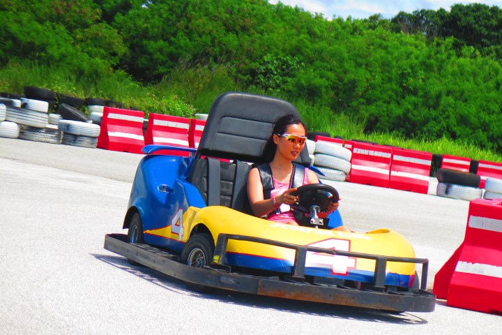 A woman having a fun time driving her go-kart