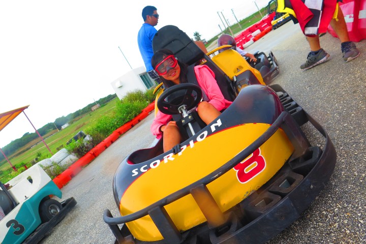 A woman having a fun time driving her go-kart