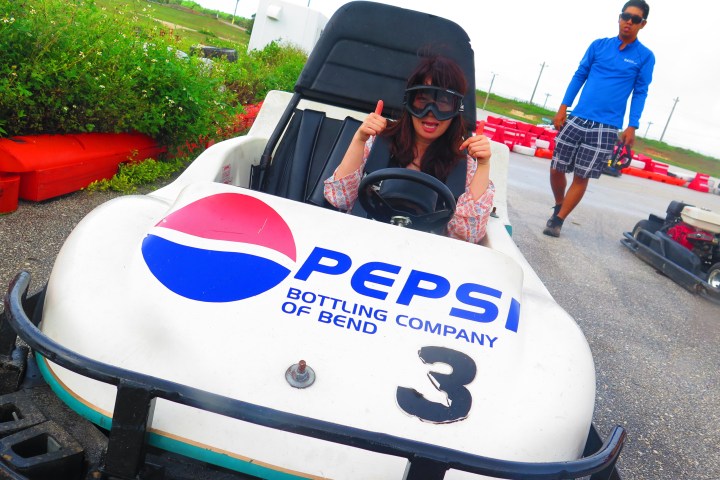 A woman having a fun time driving her go-kart