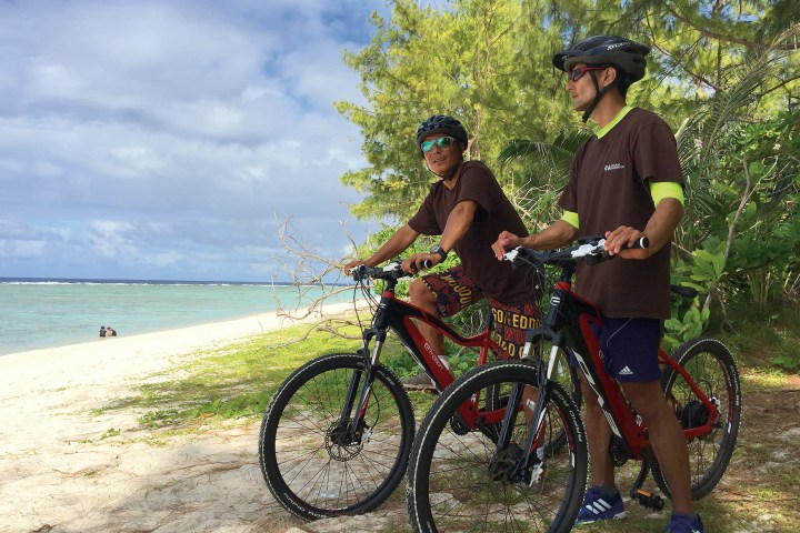 Two men posing for a photo during their bike adventure
