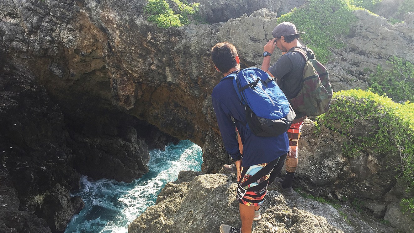 Two men looking down at the water