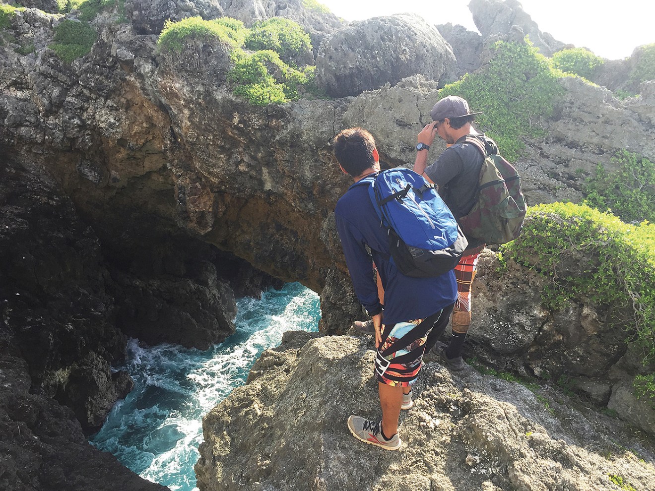 Two men looking down at the water