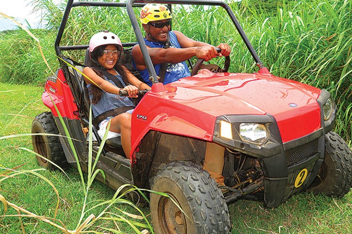 A man driving a buggy with his daughter