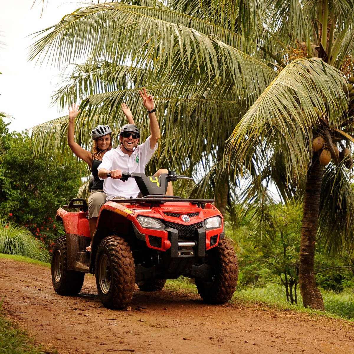 A woman riding with a guide on an ATV