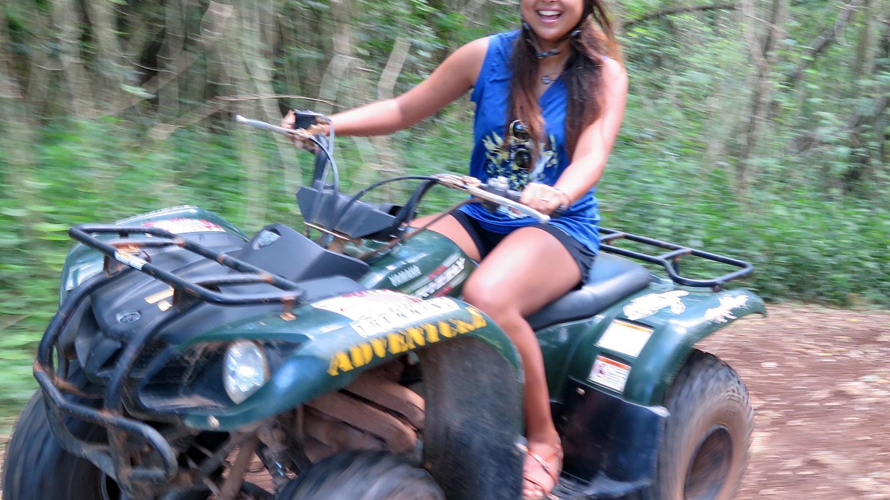 A young woman driving her ATV