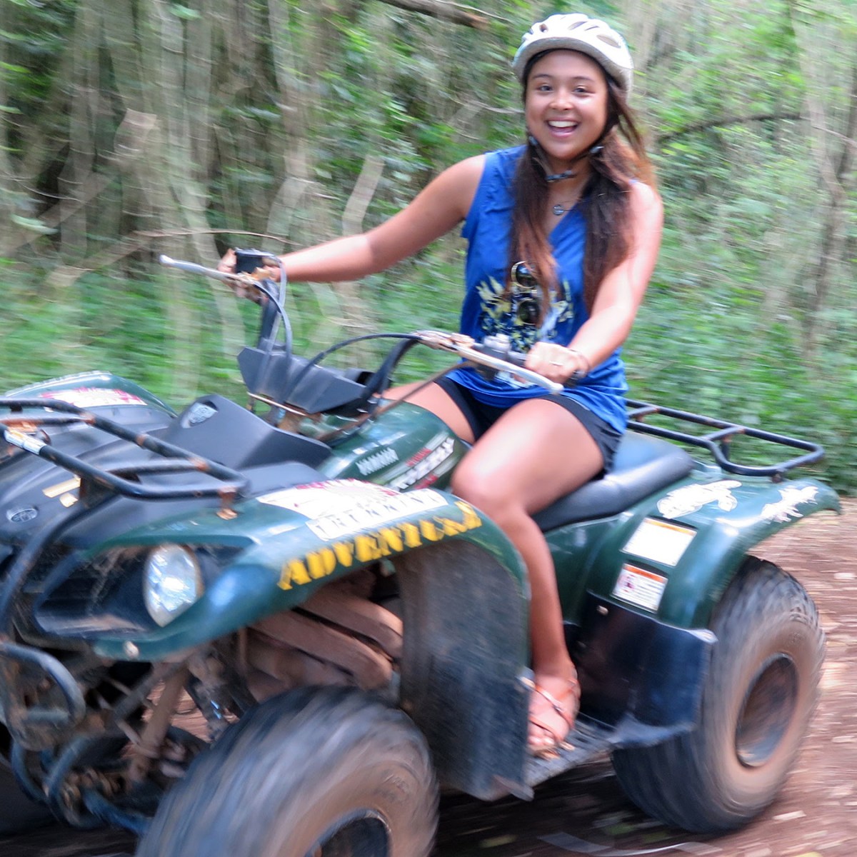 A young woman driving her ATV