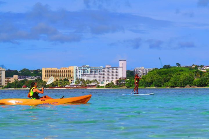 a person riding a surf board on a body of water