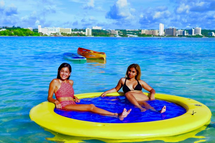 a group of people swimming in a body of water