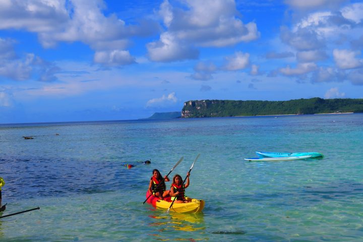 a group of people in a small boat in a body of water