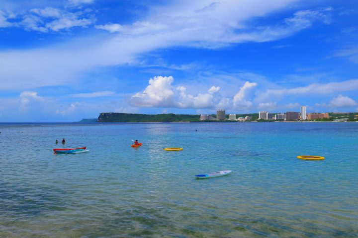 a blue and white boat floating on a body of water