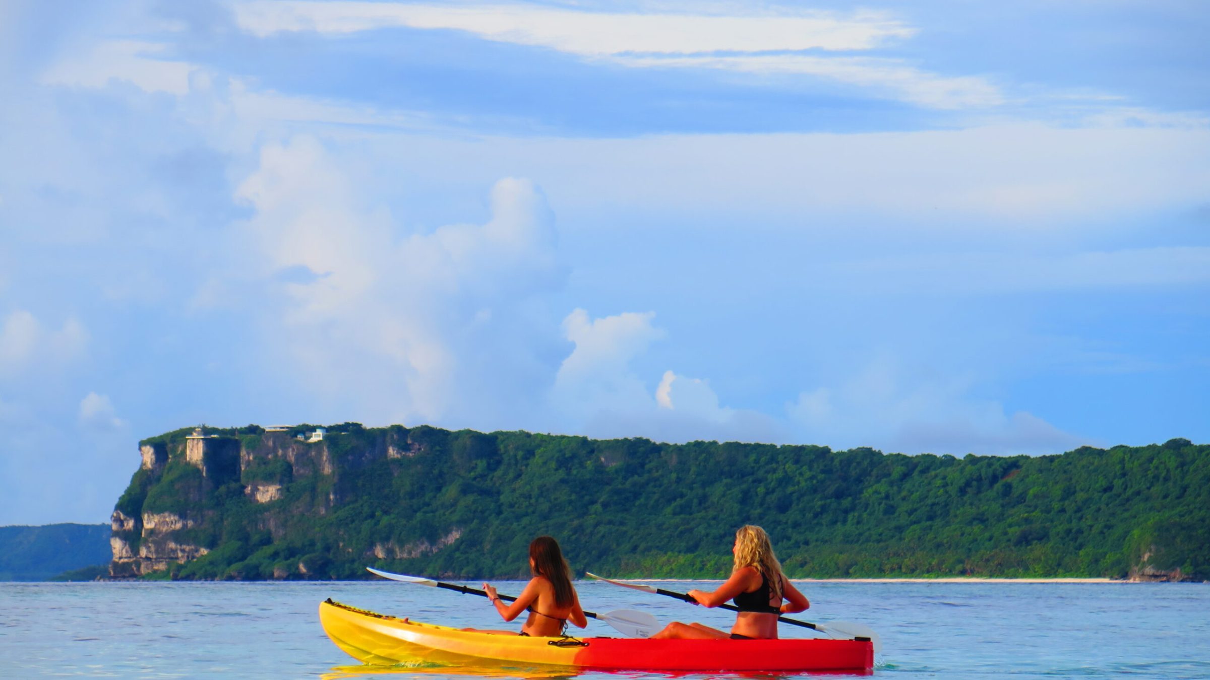 a group of people in a small boat in a body of water
