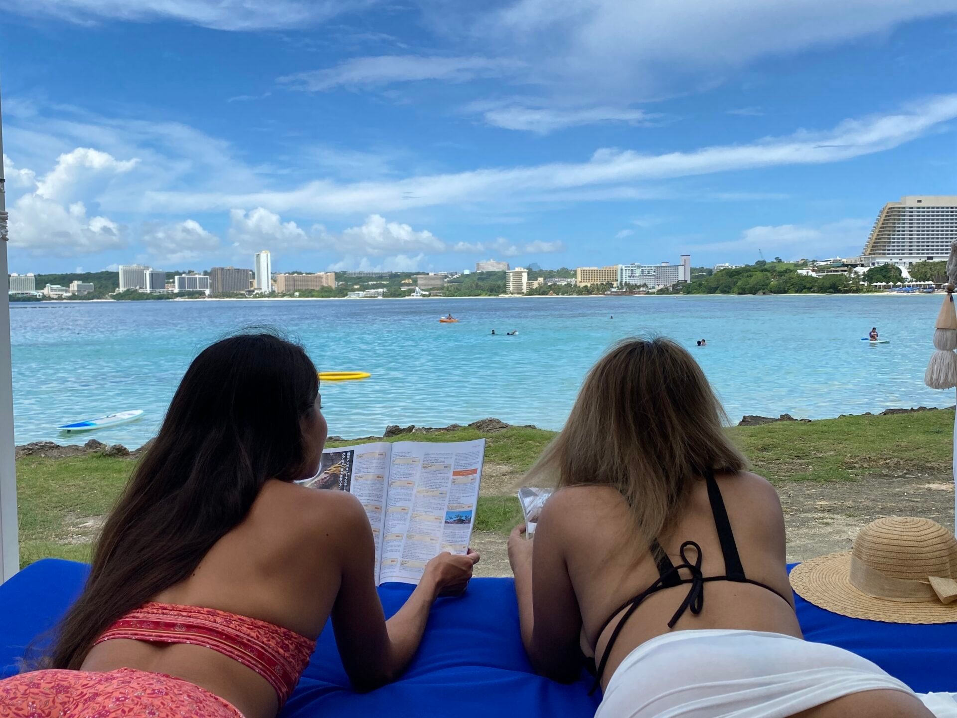 a woman sitting in front of a body of water