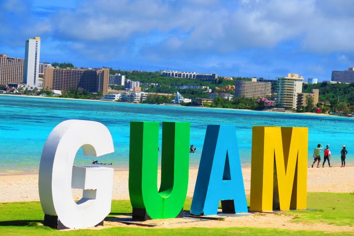 a sign in front of a body of water