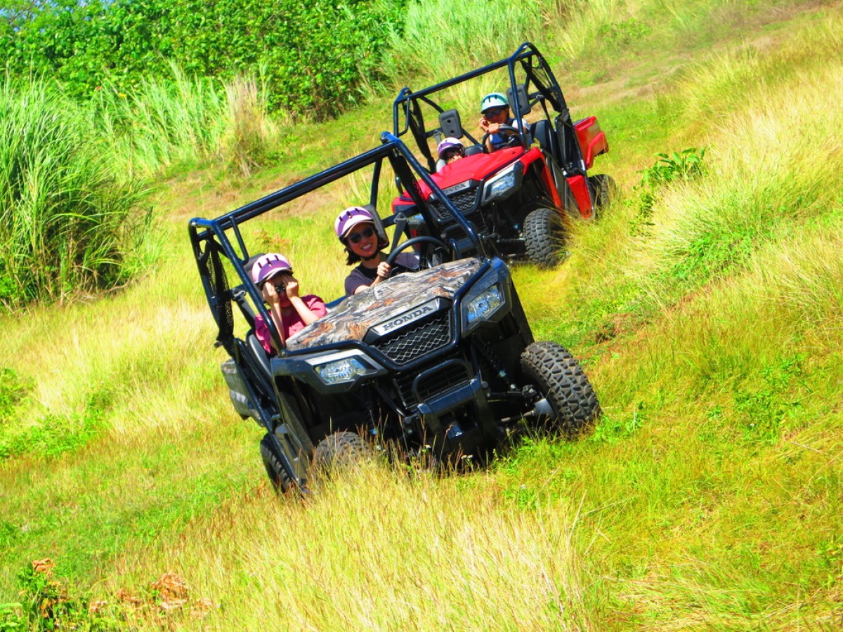 a person sitting on top of a grass covered field